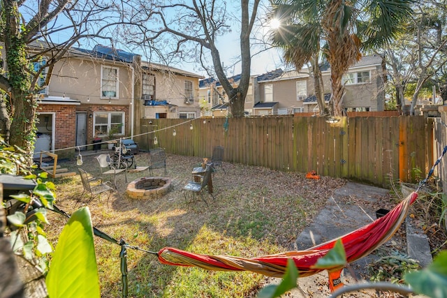 view of yard with an outdoor fire pit and fence