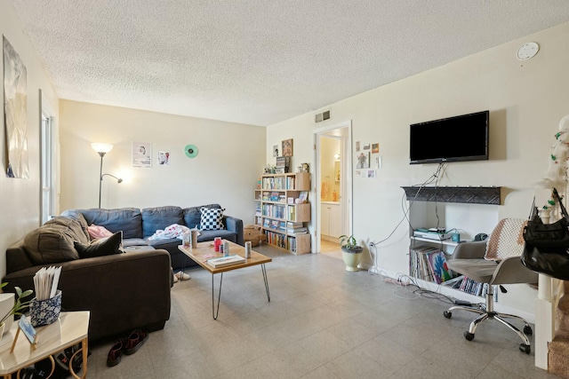 living area with visible vents and a textured ceiling