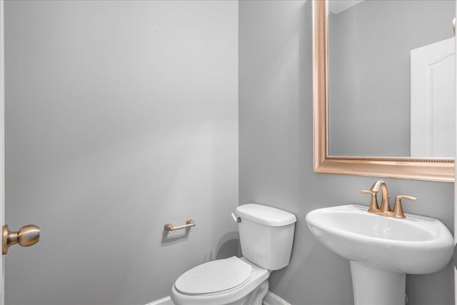 bathroom featuring toilet and sink