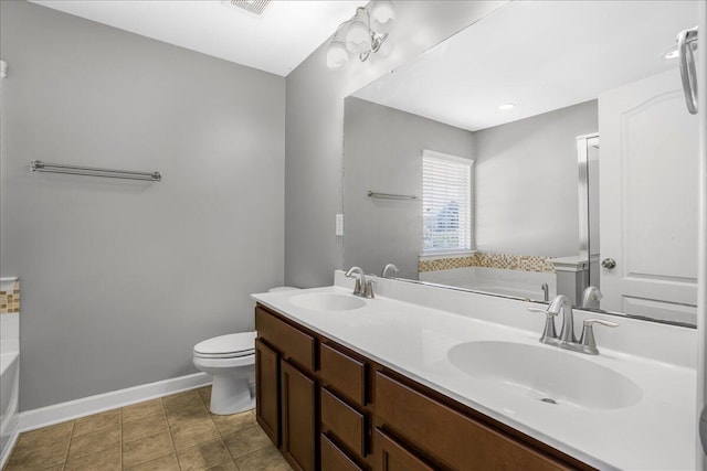 bathroom featuring toilet, vanity, tile patterned floors, and a bathing tub