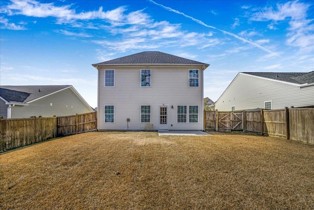 rear view of property with a lawn and a patio