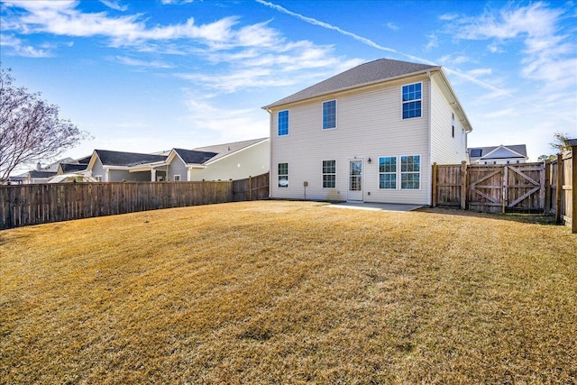 rear view of property featuring a lawn and a patio area