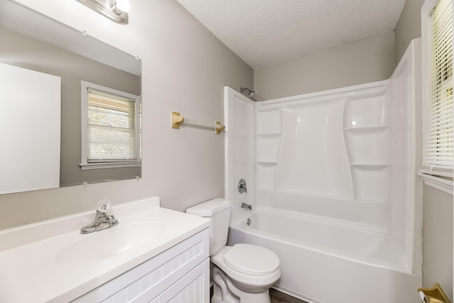 full bathroom with toilet, shower / tub combination, a textured ceiling, and vanity