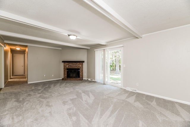 unfurnished living room with a textured ceiling, carpet flooring, beamed ceiling, and a brick fireplace