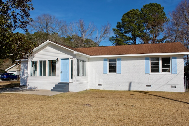 ranch-style home with a front lawn