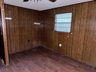 838 Ranch Hill Ln, Saint Stephen, SC 29479 - spare room with ceiling fan, wood finished floors, and wood walls