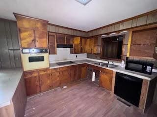 838 Ranch Hill Ln, Saint Stephen, SC 29479 - kitchen featuring black appliances, wood finished floors, brown cabinetry, a sink, and light countertops