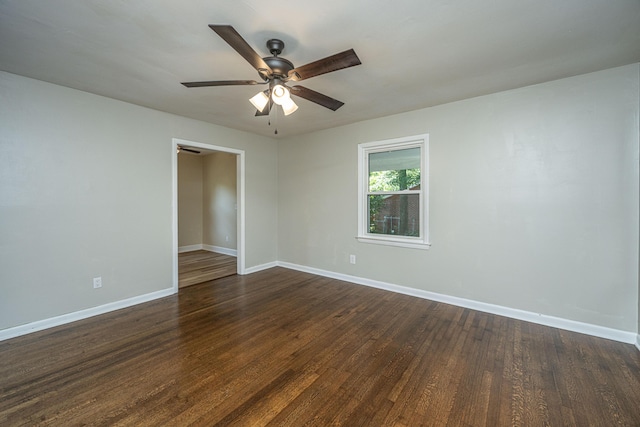 empty room featuring ceiling fan and dark hardwood / wood-style flooring