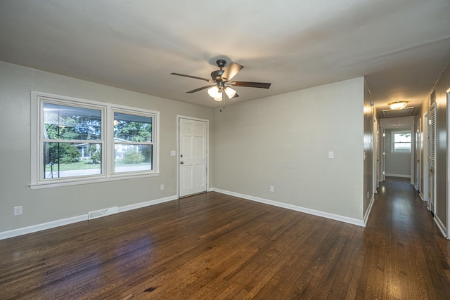 spare room with ceiling fan and dark hardwood / wood-style flooring