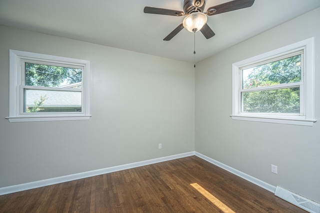 unfurnished room with ceiling fan and dark hardwood / wood-style flooring