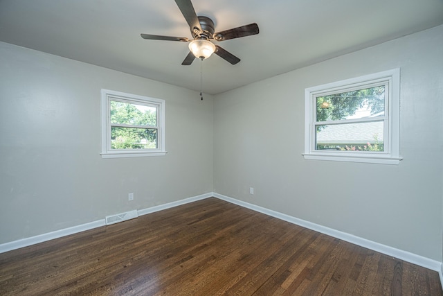 spare room with ceiling fan and dark hardwood / wood-style floors