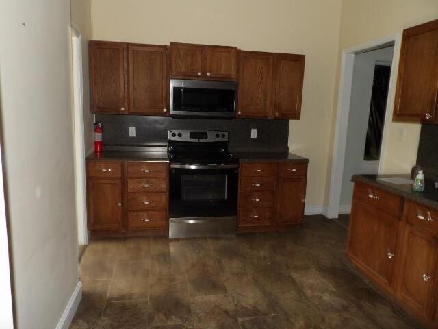 kitchen featuring decorative backsplash and appliances with stainless steel finishes