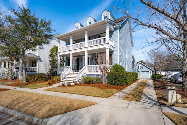 view of front facade featuring a balcony, a front lawn, a porch, and an outdoor structure