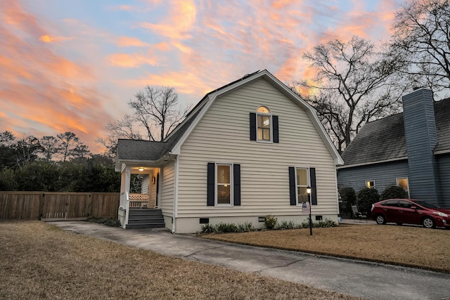 view of front property featuring a lawn and covered porch