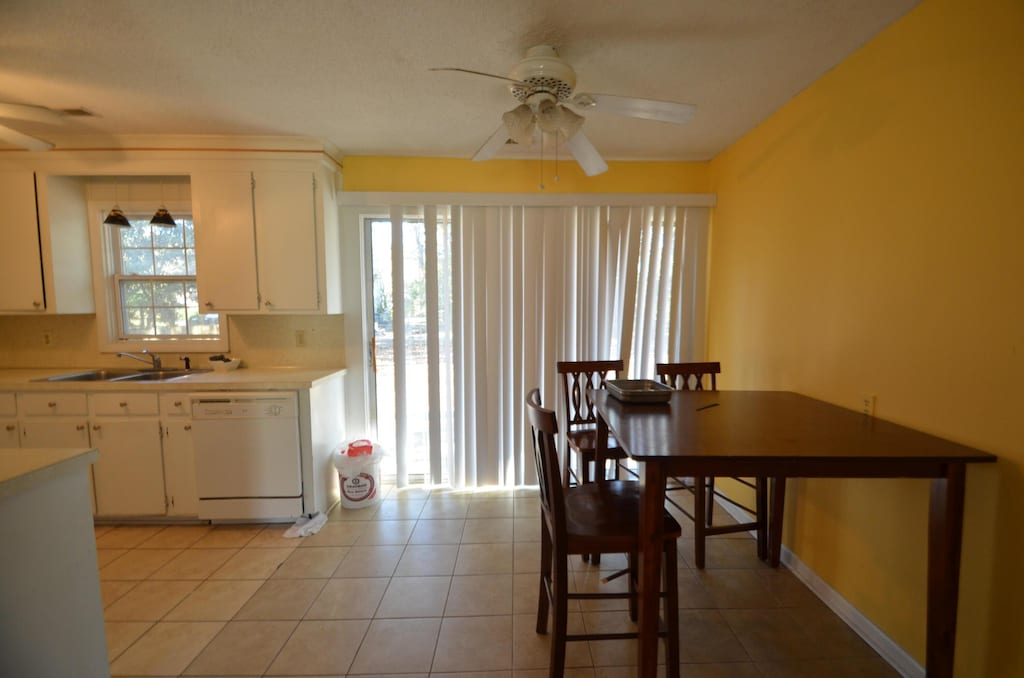 1340 Ashley Hall Rd, Charleston, SC 29407 - kitchen with dishwasher, ceiling fan, a sink, white cabinetry, and light countertops