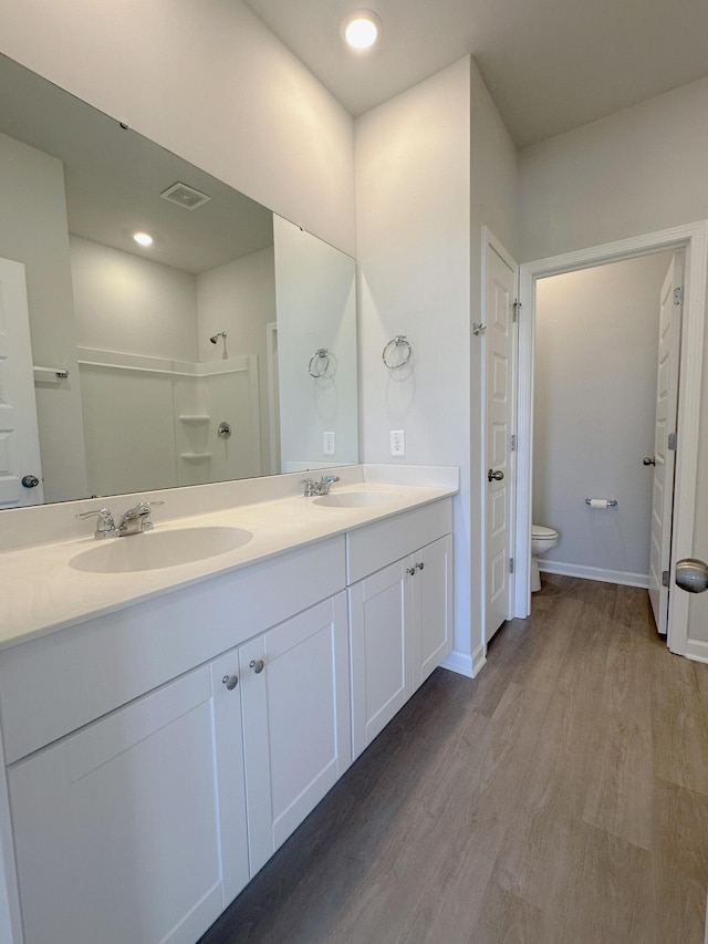 1443 Central Ave, Summerville, SC 29483 - bathroom with double vanity, wood finished floors, toilet, and baseboards