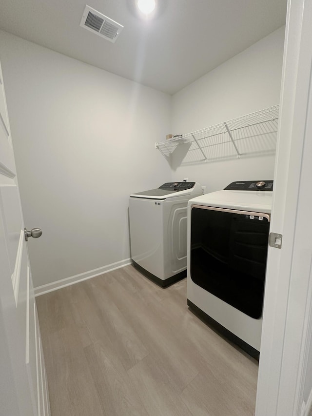 1443 Central Ave, Summerville, SC 29483 - washroom with washer and clothes dryer, light wood-type flooring, and baseboards