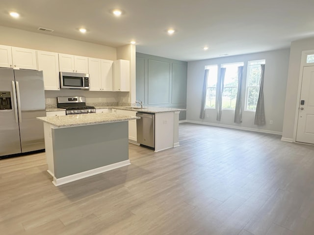 1443 Central Ave, Summerville, SC 29483 - kitchen featuring stainless steel appliances, a sink, a center island, a peninsula, and light stone countertops