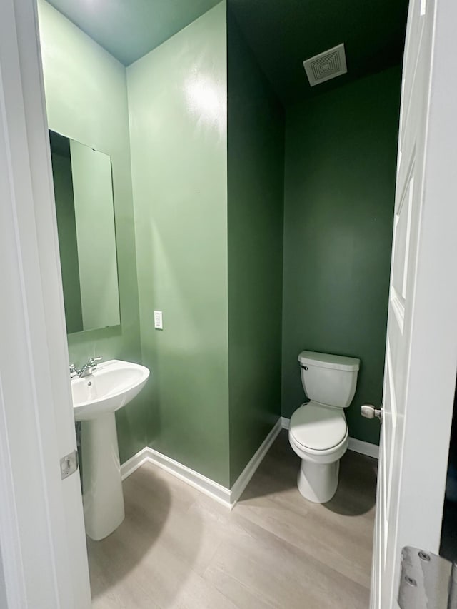 1443 Central Ave, Summerville, SC 29483 - half bathroom featuring toilet, baseboards, and wood finished floors