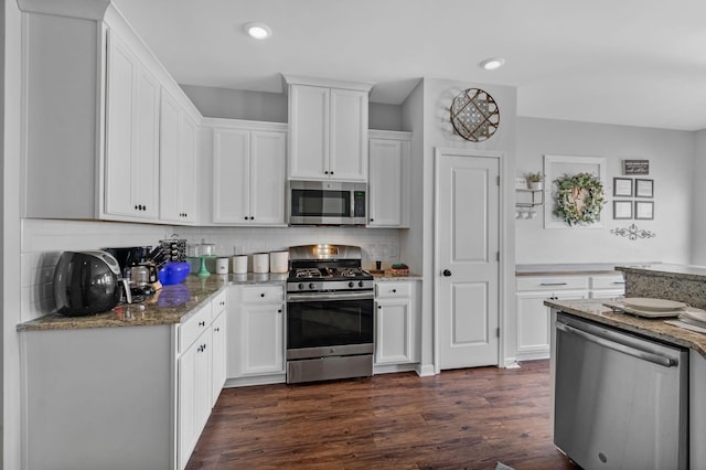 9923 Honeylocust Ln, Ladson, SC 29456 - kitchen with stainless steel appliances, white cabinets, dark wood finished floors, decorative backsplash, and recessed lighting