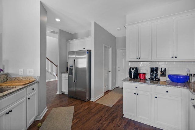 9923 Honeylocust Ln, Ladson, SC 29456 - kitchen with stainless steel fridge, white cabinets, dark wood-style flooring, tasteful backsplash, and light stone countertops