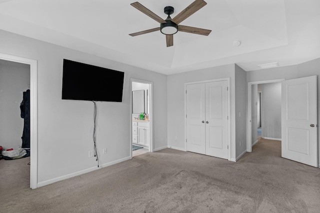 9923 Honeylocust Ln, Ladson, SC 29456 - unfurnished bedroom with carpet flooring, a closet, baseboards, connected bathroom, and a tray ceiling