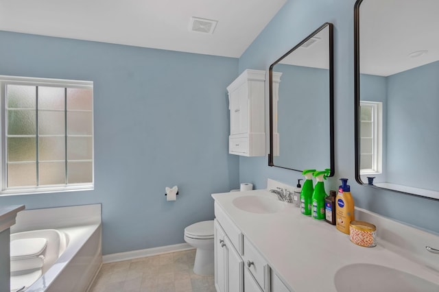 9923 Honeylocust Ln, Ladson, SC 29456 - full bathroom featuring double vanity, a garden tub, baseboards, and toilet