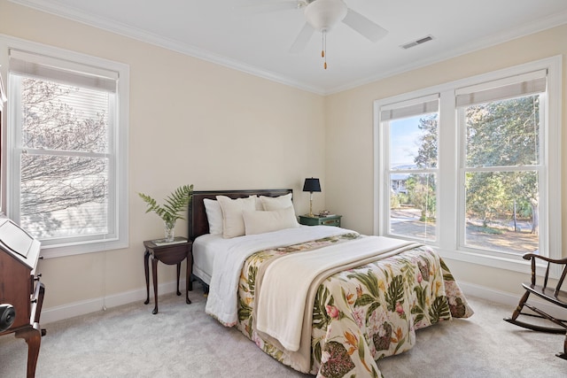 carpeted bedroom featuring baseboards, multiple windows, visible vents, and crown molding