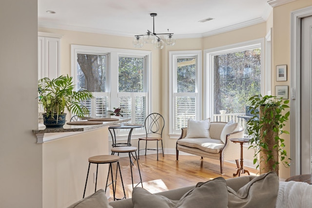 sunroom featuring visible vents and a notable chandelier