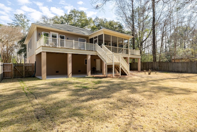 rear view of property featuring a fenced backyard, a sunroom, stairs, a yard, and a patio area