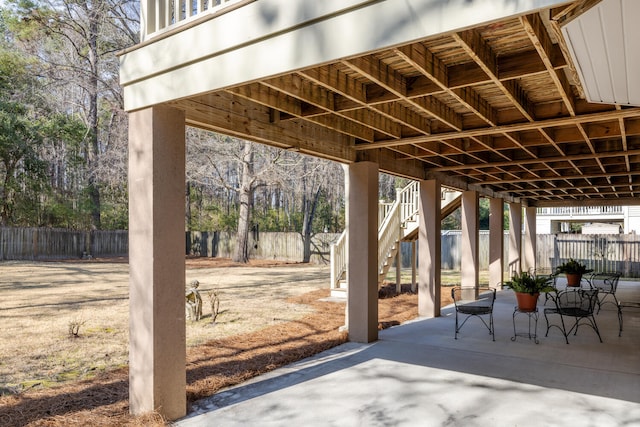 view of patio with a fenced backyard and stairs