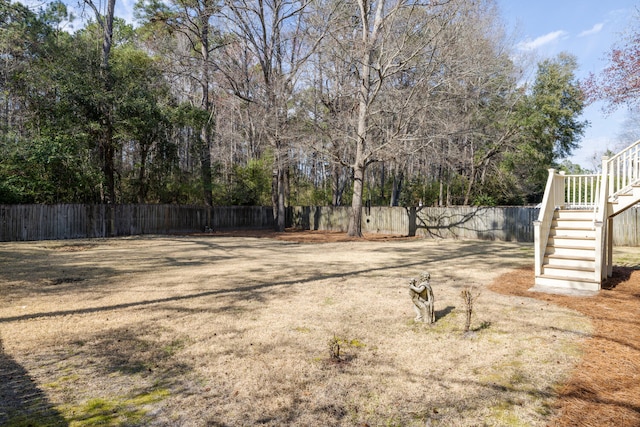 view of yard featuring stairs and fence