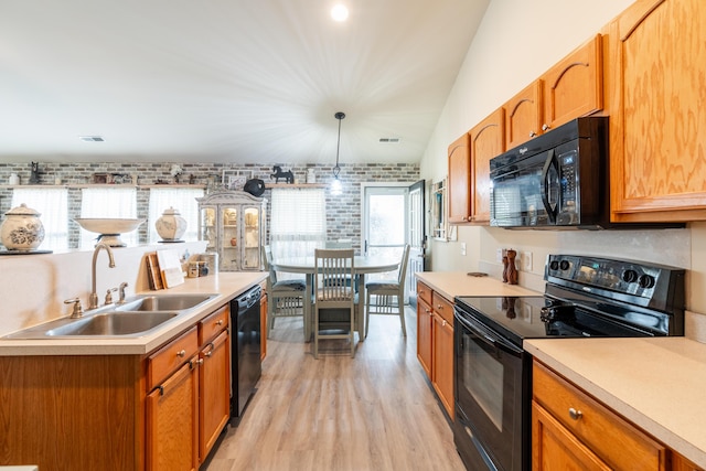 137 Salem Creek Dr, Goose Creek, SC 29445 - kitchen with black appliances, light wood-style flooring, light countertops, and brown cabinetry