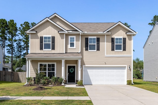 view of front of home with a front yard and a garage