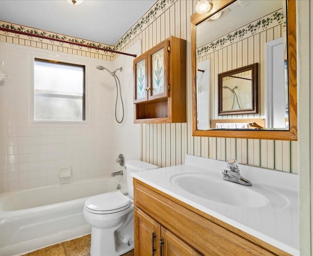 full bathroom with vanity, toilet, tiled shower / bath combo, and tile patterned flooring