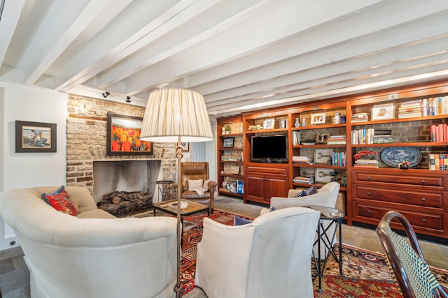 living room with a fireplace, built in features, and beam ceiling