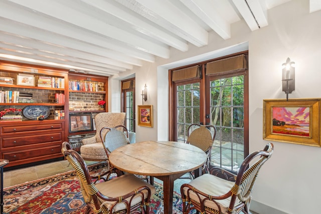 dining space with french doors, tile patterned floors, and beam ceiling