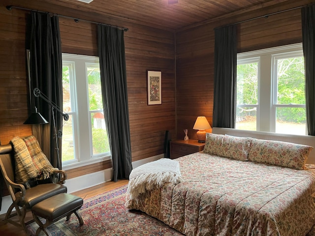 5924 Wagener Rd, Wagener, SC 29164 - bedroom featuring wooden walls, multiple windows, wooden ceiling, and wood finished floors