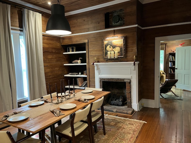 5924 Wagener Rd, Wagener, SC 29164 - dining area featuring wooden walls, a fireplace with raised hearth, and dark wood-style flooring