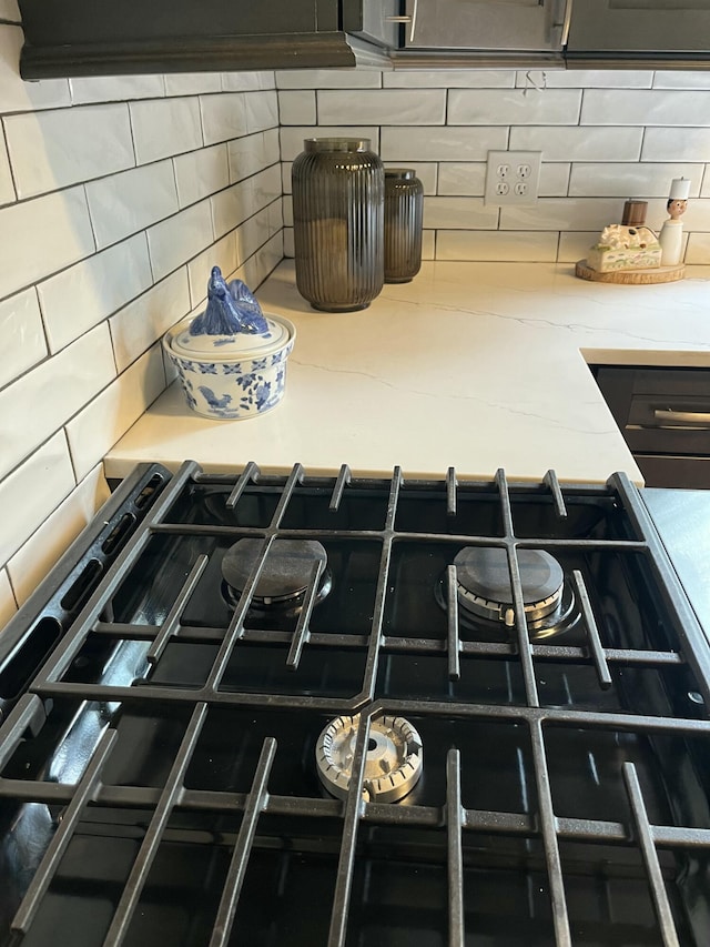 5924 Wagener Rd, Wagener, SC 29164 - kitchen view of tasteful backsplash, light stone counters, and black range with gas cooktop