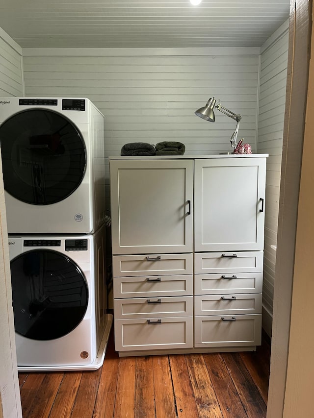 5924 Wagener Rd, Wagener, SC 29164 - laundry area with stacked washer / drying machine, cabinet space, dark wood finished floors, and wooden walls