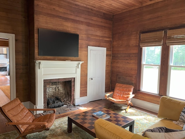 5924 Wagener Rd, Wagener, SC 29164 - living area featuring wood walls, wooden ceiling, a fireplace with flush hearth, and wood finished floors