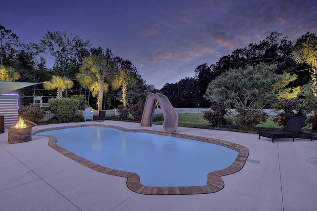 view of pool featuring a fire pit, a patio, a sink, and fence