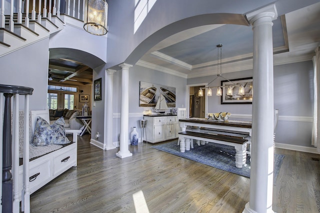 entryway featuring decorative columns, arched walkways, coffered ceiling, wood finished floors, and beam ceiling