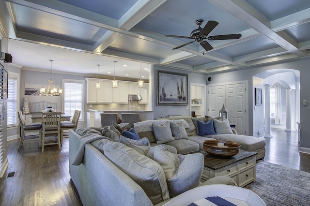 living room with arched walkways, dark wood-type flooring, coffered ceiling, and baseboards