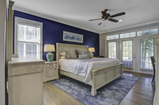 bedroom with access to exterior, multiple windows, and crown molding