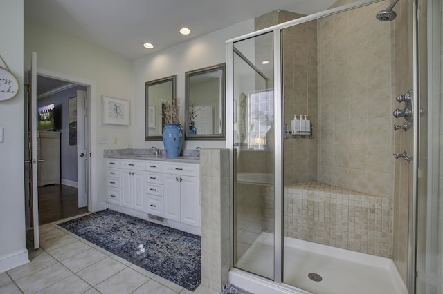 bathroom with recessed lighting, a stall shower, vanity, tile patterned flooring, and baseboards