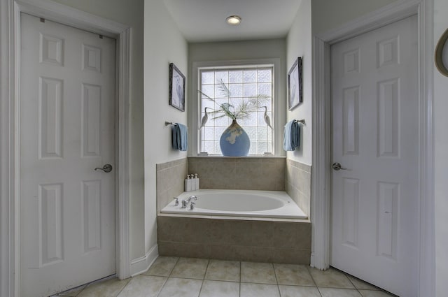 full bath featuring a garden tub and tile patterned flooring