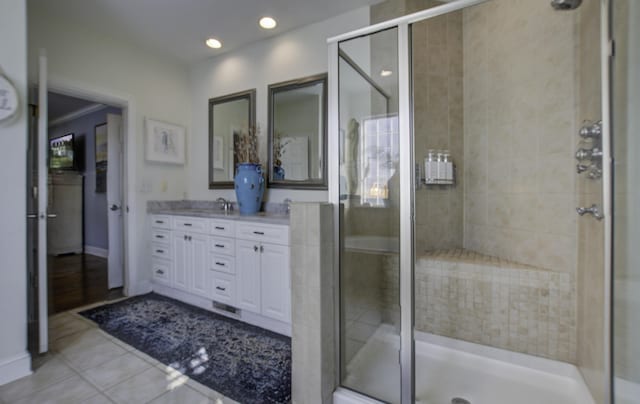 full bath with recessed lighting, a shower stall, vanity, tile patterned flooring, and baseboards