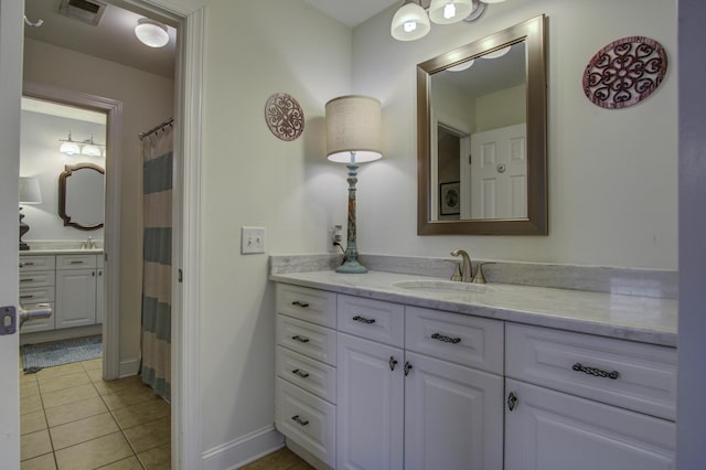 bathroom with tile patterned flooring, visible vents, vanity, and baseboards